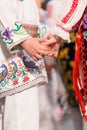 Close up of hands of young Romanian dancers perform a folk dance in traditional folkloric costume. Folklore of Romania Royalty Free Stock Photo