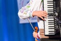 Close up of hands of young Romanian man perform a folk music on Accordion in traditional folkloric costume. Folklore of Romania Royalty Free Stock Photo