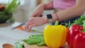 Close up of hands of young woman cutting vegetables in the kitchen. Preparing fresh vegetable salad. Dieting concept. Royalty Free Stock Photo