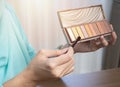 Close up hands of a young woman introducing or recommend the eye shadow palette at home Royalty Free Stock Photo