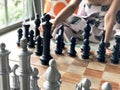 Close up of hands of young woman playing chess