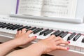 Close up of the hands of a young woman playing piano Royalty Free Stock Photo