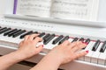 Close up of the hands of a young woman playing piano Royalty Free Stock Photo