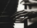 Close up of the hands of a young woman playing piano, selective Royalty Free Stock Photo