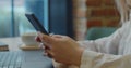 Close-up hands of young woman using mobile phone social media checking email box messages sitting in the cafe. Royalty Free Stock Photo