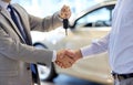 Close up of handshake in auto show or salon Royalty Free Stock Photo