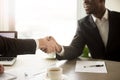 Close up of handshake between black and white business partners