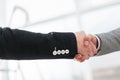 close up. handshake of business people on the background of a bright office Royalty Free Stock Photo