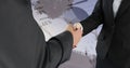 Close up of a handshake between a businessman and a businesswoman