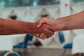 Close up a handshake, businessman together creates a mutually beneficial business relationship. The economic graph on