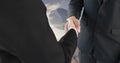 Close up of a handshake between businessmen with a background of a wide open field