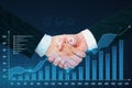 Close up of handshake with growing digital business chart on blue background. Business strategy development, teamwork and growth Royalty Free Stock Photo