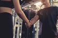 Close up handshake of sporty young asian woman with man greeting partner exercise workout at fitness gym