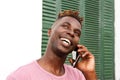 Close up handsome black guy standing outside and talking on mobile phone Royalty Free Stock Photo