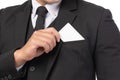 Close up handsome business man in black suit put or take out credit card in pocket isolated on white background. Business, Royalty Free Stock Photo