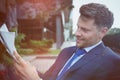 Close up of handsome businessman reading newspaper