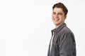 Close up of handsome happy candid boy, young man turn face at camera with white smile, positive cheerful face, looking