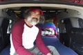 Close-up of a handsome man in a cap smiling sitting inside a camping van Royalty Free Stock Photo