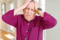 Close up of handsome senior man at home suffering from headache desperate and stressed because pain and migraine Royalty Free Stock Photo