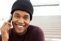 Close up handsome young african american man smiling and talking with cellphone Royalty Free Stock Photo
