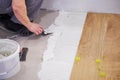 Close-up of handyman placing tile spacer. Placing the floor tiles. Home improvement