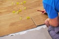 Close-up of handyman placing tile spacer. Placing the floor tiles. Home improvement