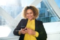 Close up happy african american business woman in the city with cellphone Royalty Free Stock Photo