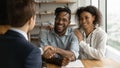 Close up happy African American family and manager realtor handshaking Royalty Free Stock Photo