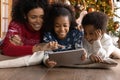 Close up happy African American family using tablet, celebrating Christmas Royalty Free Stock Photo