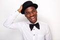 Close up happy african american man with bowtie and hat against white background Royalty Free Stock Photo