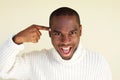 Close up happy african american man with finger pointing to head Royalty Free Stock Photo