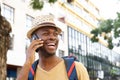 Close up happy african american man with hat talking on cellphone Royalty Free Stock Photo