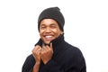 Close up happy african american man keeping warm with winter jacket and beanie against white background Royalty Free Stock Photo