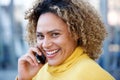 Close up happy african american woman with curly hair talking on mobile phone Royalty Free Stock Photo