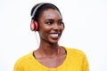 Close up happy african american woman listening to music with headphones against isolated white background Royalty Free Stock Photo