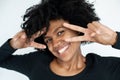 Close-up of happy African American woman making victory gesture Royalty Free Stock Photo