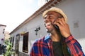 Close up happy african american young man talking with cellphone outside Royalty Free Stock Photo