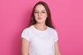 Close up of happy attractive young woman student with long staraight hair, wearing white casual t shirt and glasses, attractive Royalty Free Stock Photo