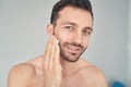 Positive young man smiling before starting shaving procedure Royalty Free Stock Photo