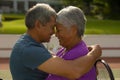 Close-up of happy biracial senior couple with eyes closed and face to face romancing at tennis court Royalty Free Stock Photo