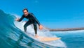 CLOSE UP: Happy male surfer riding a wave and giving the camera the shaka sign. Royalty Free Stock Photo