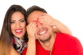 Close up of happy couple isolated on white background. Attractive man and woman being playful, woman putting her hands Royalty Free Stock Photo