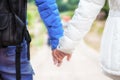 Close-up of a happy couple in love holding hands and walking tog