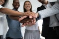 Close up happy diverse business people putting hands together. Royalty Free Stock Photo