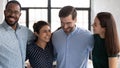 Close up happy diverse employees hugging, celebrating success Royalty Free Stock Photo