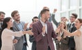 Happy entrepreneur standing in front of his business team Royalty Free Stock Photo