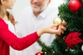 Close up of happy family decorating christmas tree Royalty Free Stock Photo