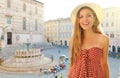 Close up of happy fashion girl traveling in Italy. Beautiful woman visiting the old medieval city of Perugia, Italy