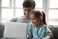Close up happy father and little daughter using laptop together Royalty Free Stock Photo