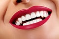 Close-up Happy Smile with Healthy White Teeth, Bright Red Lips Make-up. Cosmetology, Dentistry and Beauty care Royalty Free Stock Photo